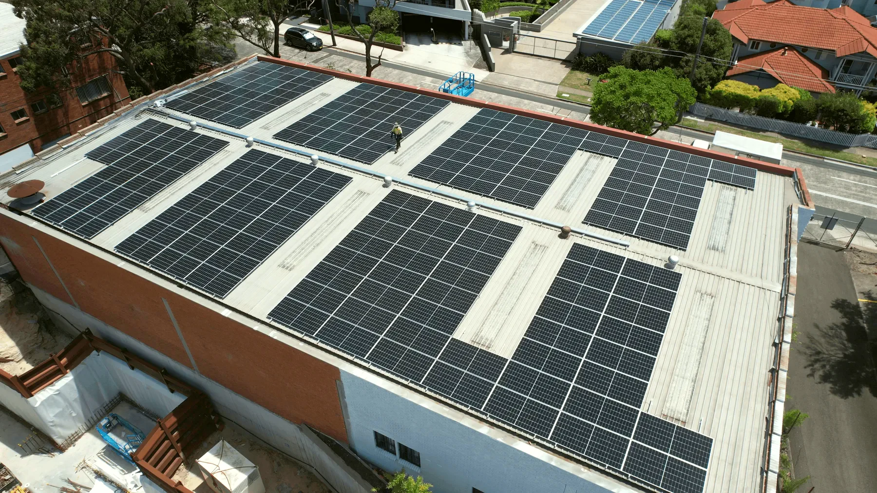 A residential roof array photographed close to the plane, panel frames and rail visible.