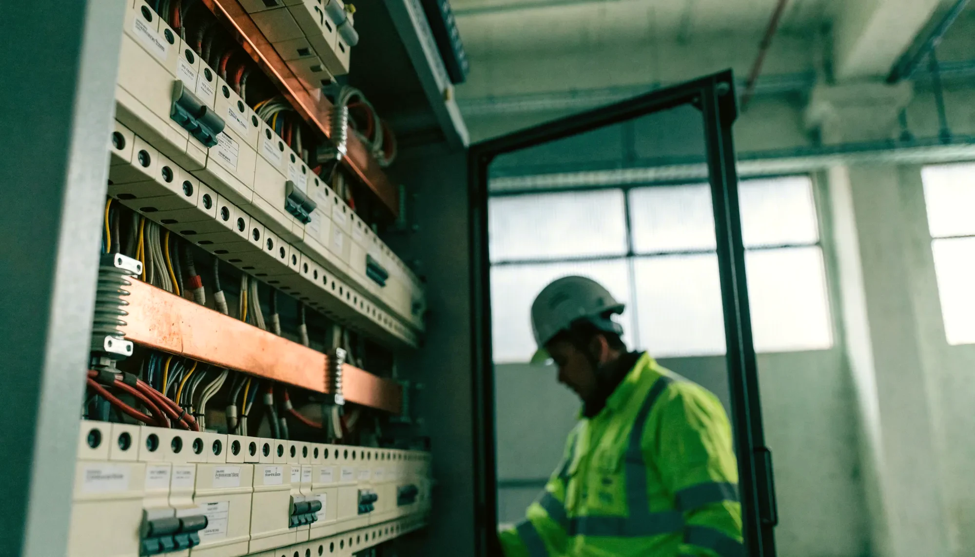 A commercial switchboard with the door open, breakers and labelled circuits visible.
